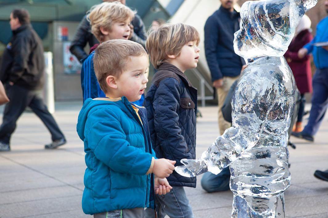 Children playing with Ice Sculptures