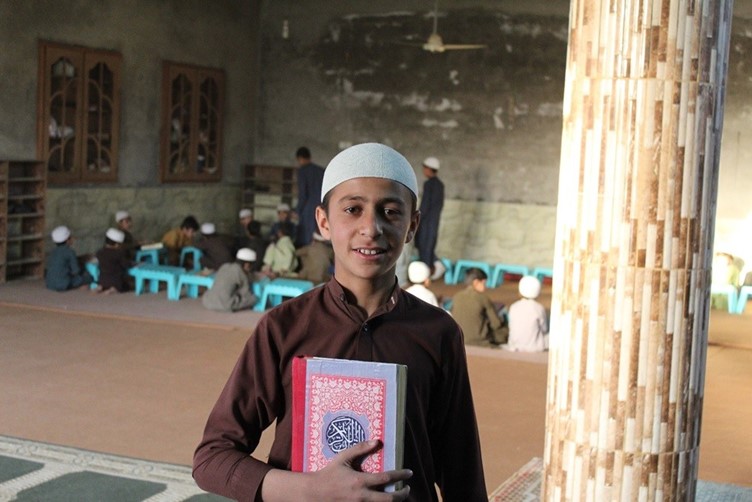 Boy holding the Qur’an