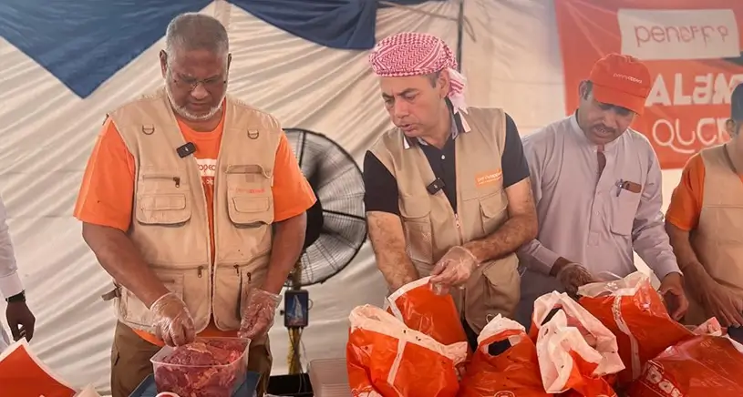 Penny Appeal workers pack Qurbani meat into bags.
